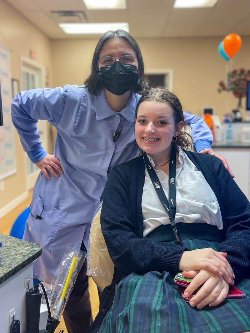 Appalachian orthodontics of lynchburg-dr. Elena-black-orthodontic-patient A patient smiling with a nurse