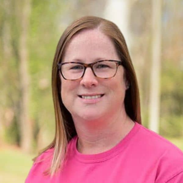 Amy team photo smiling outside Our team