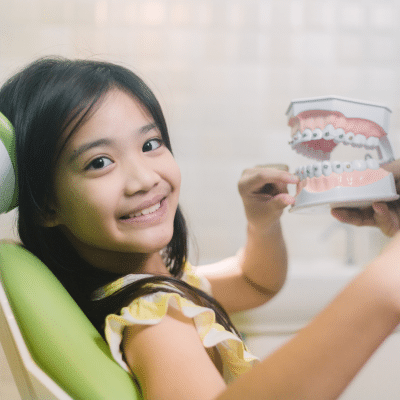 The benefits of early orthodontic intervention 6 Little girl smiling at the orthodontist, representing early orthodontic intervention