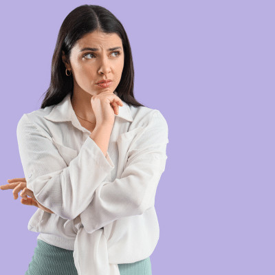 What's the best orthodontic treatment for adults? 3 Woman in white blouse, thoughtful pose, representing best orthodontic treatment for adults